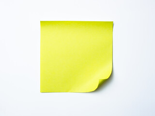 Single yellow sticky note with curled corner placed on a clean white background.