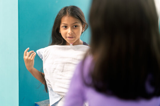 Girl preparing for swimming lesson holding towel