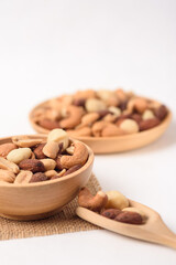 Mixed nuts consisting of almonds, cashews and peanuts, roasted with salt. Healthy snack on white background.