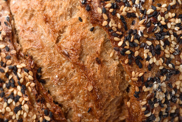 Healthy vegan dark rye sourdough bread topped with sesame and flaxseed