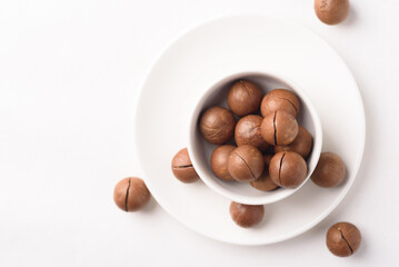 Fresh organic macadamia nuts on white background