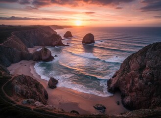 Coastal cliffs meet the ocean as a vibrant sunset paints the sky with golden hues