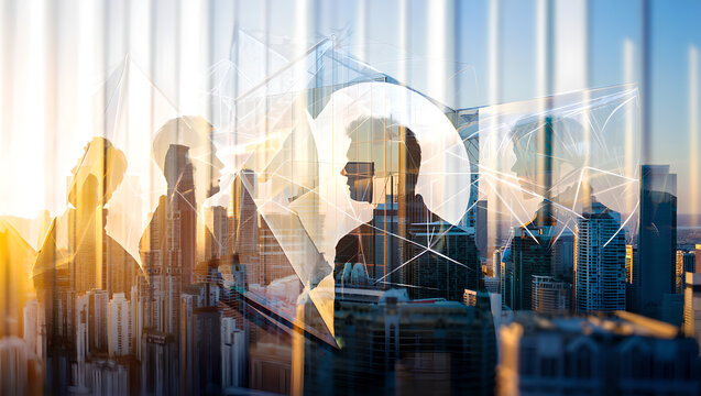 Silhouettes of business people overlaid on a cityscape at sunset with geometric network graphics.