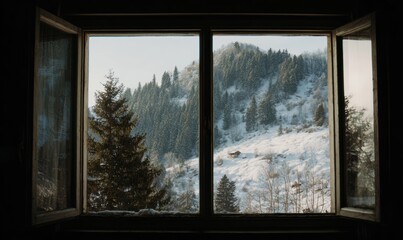 A window with a view of a snowy mountain and trees