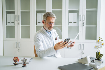 Doctor using smart phone for healthcare and medical consultations