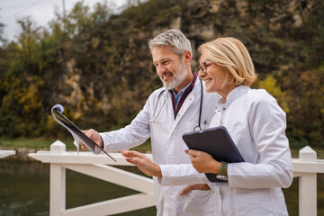 Medical professionals discussing patient charts outdoors