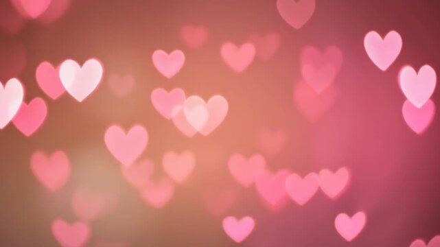 Playful floating pink heart shapes on a soft glowing background conveying love, romance, and cheerful celebration mood.
