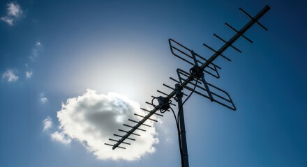 TV Antenna Against Blue Sky and Cloud