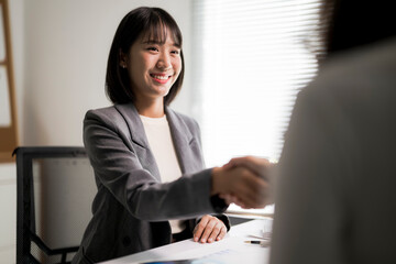 Businesswomen shaking hands completing professional office deal