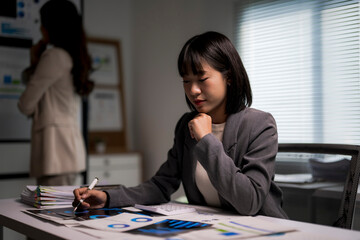 Businesswoman analyzing financial data late night working overtime