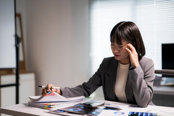 Stressed asian businesswoman having headache from office workload