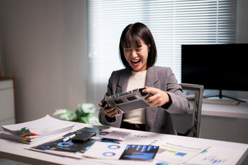 Asian businesswoman finding work-life balance playing game