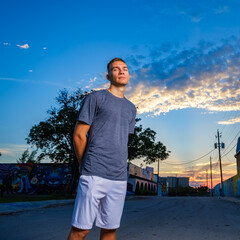 Handsome young man in a downtown urban setting at sunset