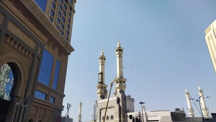 Sunny Low Angle Masjid al-Haram Minaret Under Construction Against Blue Sky
