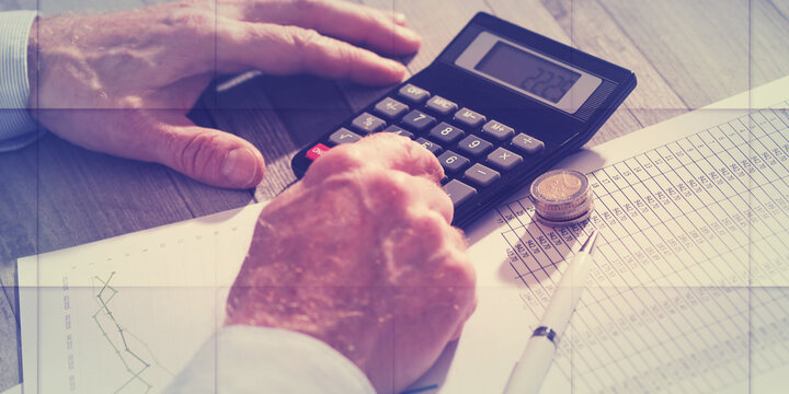 Hands of an accountant working on financial documents, geometric pattern
