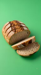 A loaf of freshly baked bread with slices cut and placed on a vibrant green background, showcasing its crust and soft interior in a close-up shot