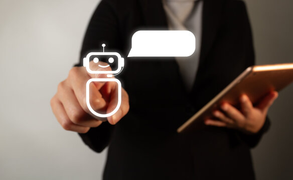 Interact with Artificial Intelligence businesswoman holding a tablet while pointing at a chatbot icon