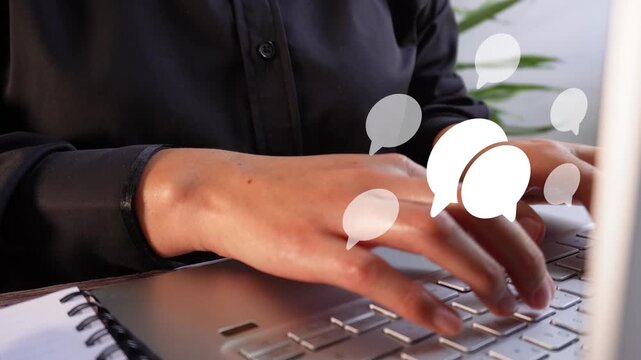 Close-up of a professional woman's hands using a computer with online chat animation
