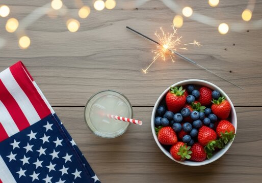 Festive Fourth of July flat lay with American flag, sparkler, and berries. Top view of patriotic summer celebration on rustic wood. Perfect for Independence Day, Memorial Day, or Labor Day themes.