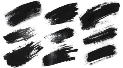 A set of nine black paint brush strokes arranged on a black background in a scattered pattern