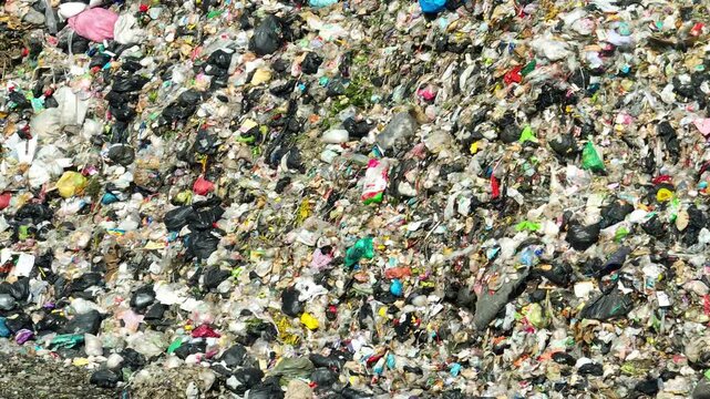 Aerial perspective of dense garbage accumulation revealing waste pollution, environmental pressure, overconsumption issues, flawed waste systems, and the growing need for sustainability awareness.
