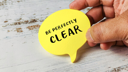 Hand Holding a Yellow Speech Bubble with the Text 