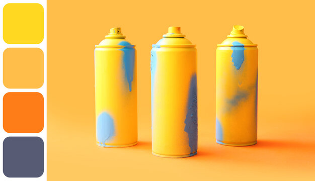 Spray paint cans on orange background