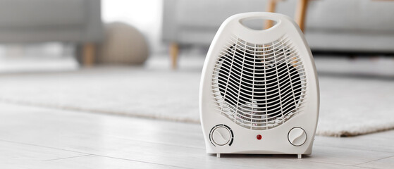 Electric fan heater on floor in living room