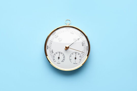 Aneroid barometer on blue background