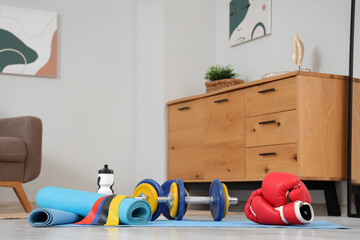 Naklejka premium Sports equipment on floor in living room