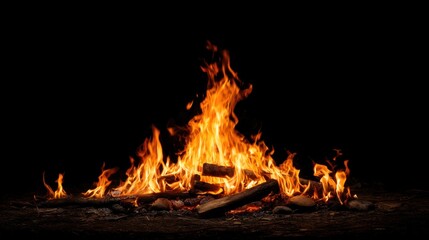 A large, intense fire with bright orange flames and embers, surrounded by dark, smoky smoke, against a black background. 