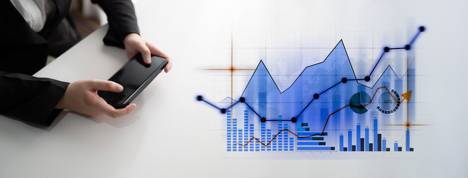 A business professional reviews market trends using a smartphone, accompanied by digital graphs illustrating financial growth and analytical insights for strategic decisions. Scalp - Powered by Adobe