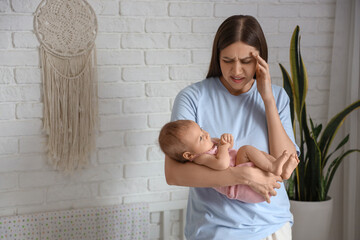 Young woman suffering from postnatal depression  at home