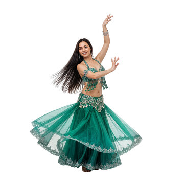 Elegant young Indian woman performing a beautiful belly dance, raising arms in a vibrant green traditional costume on an isolated transparent background.