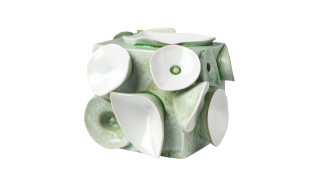 Green cube adorned with white petal-like shapes, creating abstract floral design on a black background - Powered by Adobe