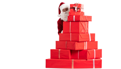 Santa claus peeking behind a large stack of red christmas presents with silver ribbons on white background