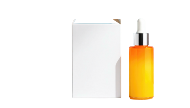 Orange oil in glass bottle with dropper next to a white box, isolated on black. Bright lighting