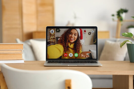 Open video chat with woman on laptop in living room, closeup