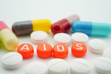 AIDS Acquired immunodeficiency syndrome word with pills and capsules medical drug.