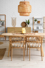 Dining table with candles in interior of living room