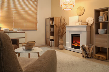 Naklejka premium Interior of cozy living room with fireplace, armchair and coffee table