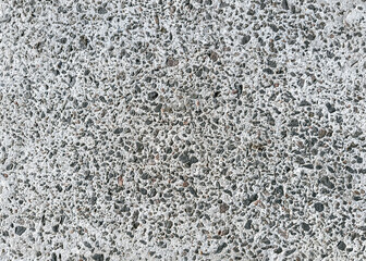 grainy cement floor with small dark stones. construction background. high resolution.