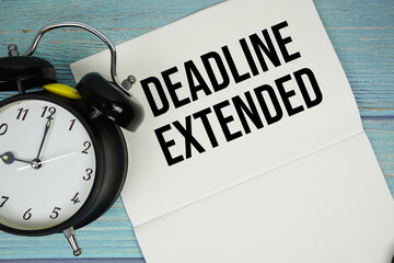 Notepad on a blue wooden table with the words 