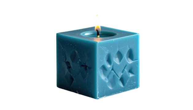 Teal cube candle, with textured surface, and flame, stands out against a stark black background