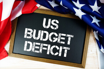 American flag with blackboard "US Budget Deficit" on wooden background