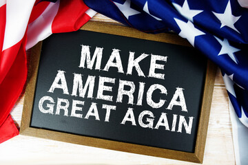 American flag with blackboard  "Make America Great Again" on wooden background