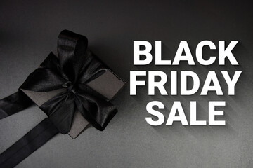 Black Friday Sale text with gift box present on black background
