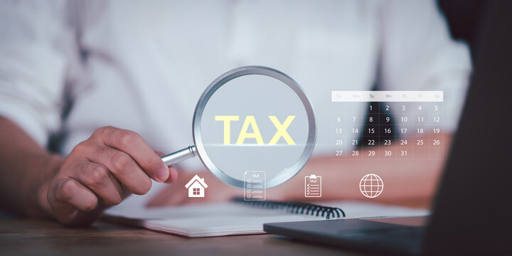 businessman using magnifying glass to examine word TAX with icons of documents and a calendar, symbolizing tax inspection, financial analysis, preparation for annual filing and government compliance.