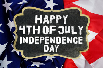 Happy 4th of July Independence Day written on blackboard with USA flag background