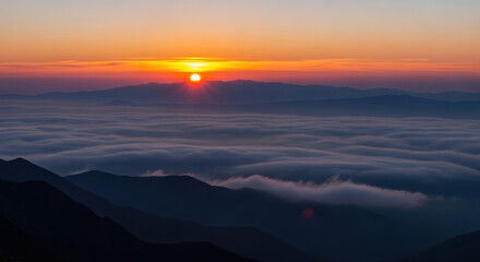 Breathtaking Sunrise Over Mountain Peaks with Clouds, Capturing the Serene Beauty of Nature and the Golden Light of Dawn in a Dramatic Landscape Panorama